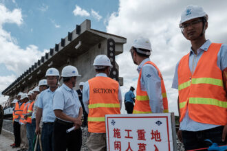 Minister for Development Cooperation and Metropolitan Policy Caroline Gennez (L) visits a solar power project during a visit to the packaging unit