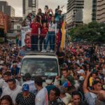 Opposition leaders María Corina Machado, in white, and Edmundo González, in red, during a rally for González’s presidential campaign, in Caracas, Venezuela, July 4, 2024. (Adriana Loureiro Fernandez/The New York Times)