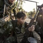 Rebel soldiers ride in the back of a pickup truck in southern Karenni State, in Myanmar, on Jan. 28, 2024. (Adam Ferguson/The New York Times)