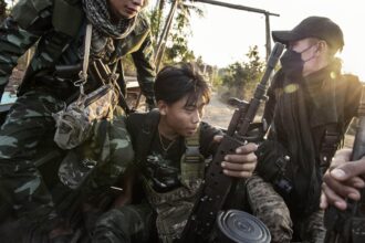 Rebel soldiers ride in the back of a pickup truck in southern Karenni State, in Myanmar, on Jan. 28, 2024. (Adam Ferguson/The New York Times)