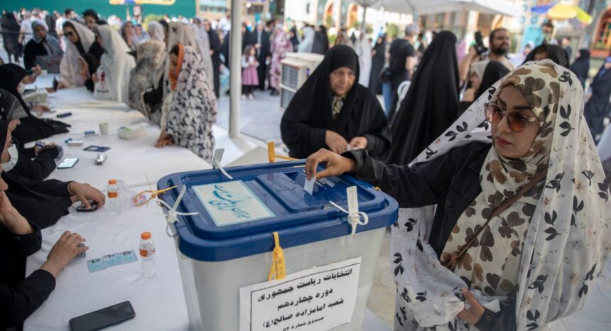 a woman putting a slip of paper into a ballot box